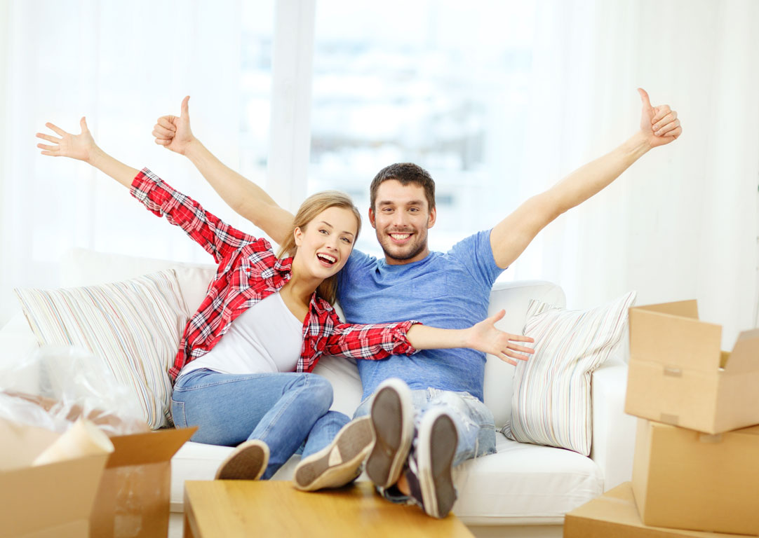 Two people celebrating on a sofa